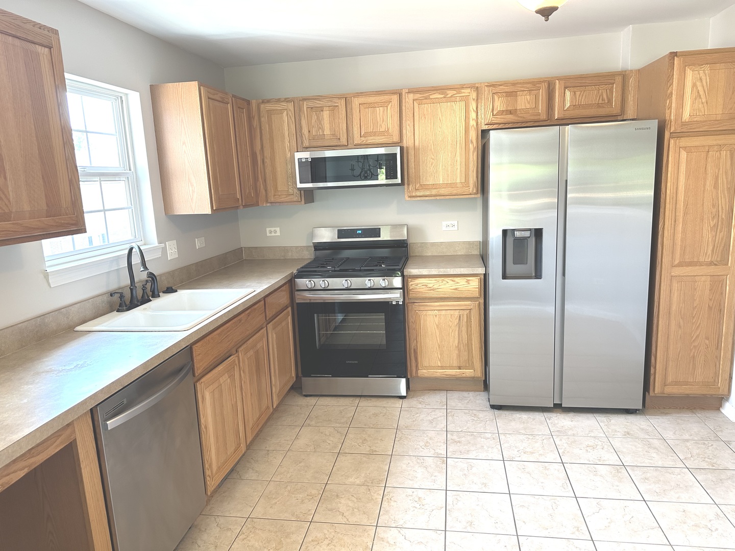 5900 Dublin Court, Unit 5900 McHenry, IL 60050 - Photo 4 of 14 a kitchen with a refrigerator sink and cabinets