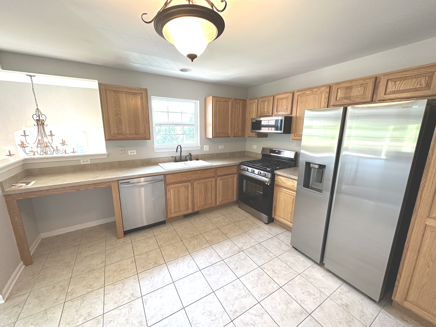 5900 Dublin Court, Unit 5900 McHenry, IL 60050 - Photo 5 of 14 a kitchen with stainless steel appliances granite countertop a sink stove and refrigerator