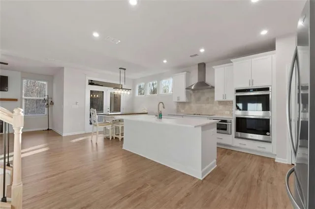 a large white kitchen with a lot of counter space