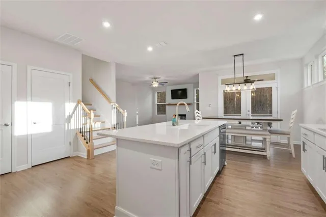 a kitchen with stainless steel appliances granite countertop a sink and cabinets