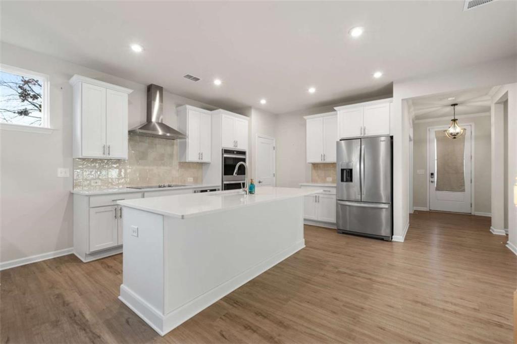15 Parkside View Cartersville, GA 30121 - Photo 15 of 43 a large kitchen with stainless steel appliances a refrigerator a stove a sink dishwasher and a oven with wooden floor