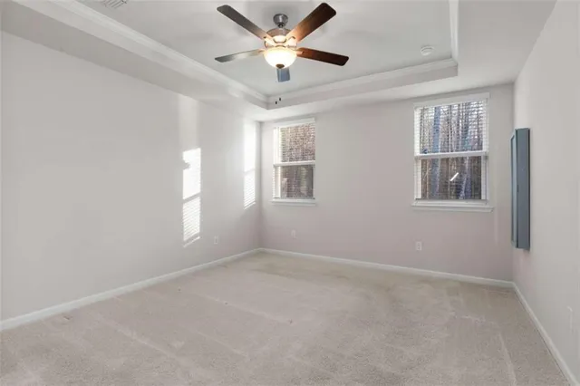 an empty room with closet and a ceiling fan