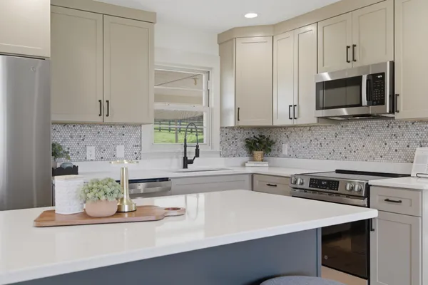 a kitchen with stainless steel appliances a stove microwave and sink