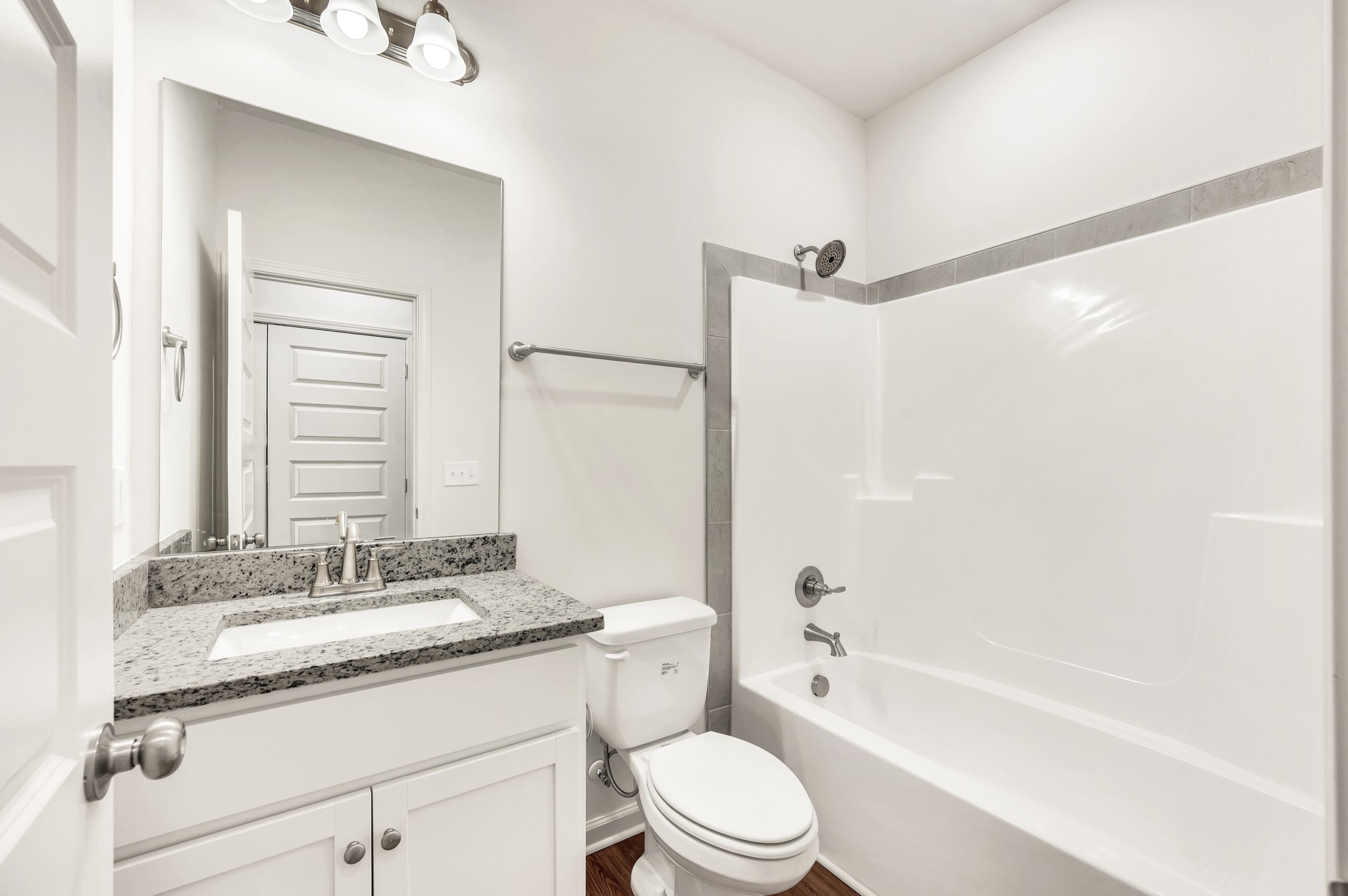 7103 Wiley Circle Fairview, TN 37062 - Photo 26 of 33 a bathroom with a granite countertop bathtub shower sink vanity mirror and toilet