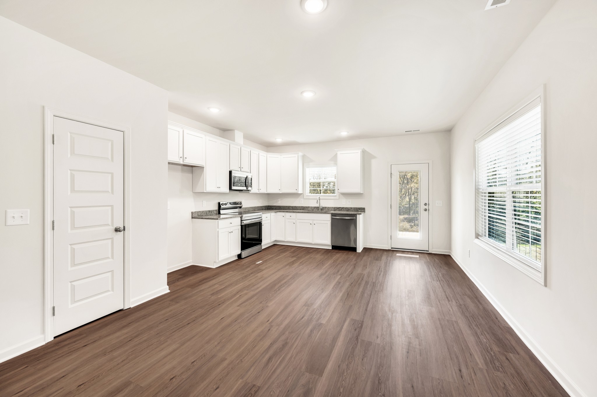 7103 Wiley Circle Fairview, TN 37062 - Photo 9 of 33 a view of kitchen with wooden floor electronic appliances and window