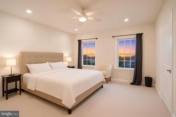 a large bedroom with a large bed and a chandelier