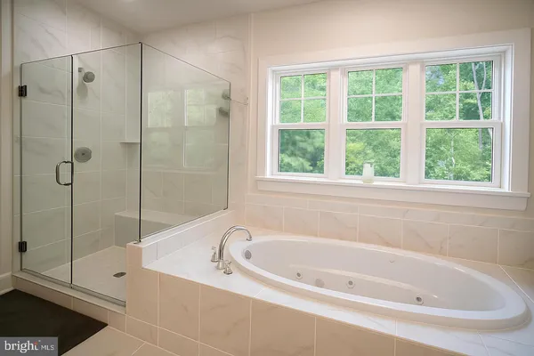 a bathroom with a bathtub and shower