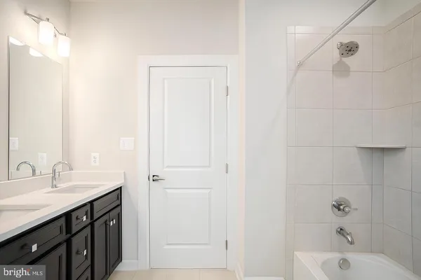 a bathroom with a sink a mirror and a bathtub