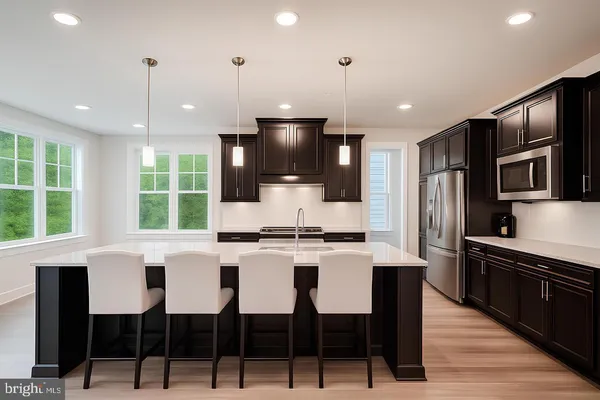 a kitchen with stainless steel appliances kitchen island granite countertop a stove a refrigerator a sink a dining table and chairs with wooden floor