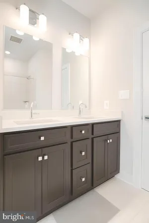 a bathroom with a double vanity sink and mirror