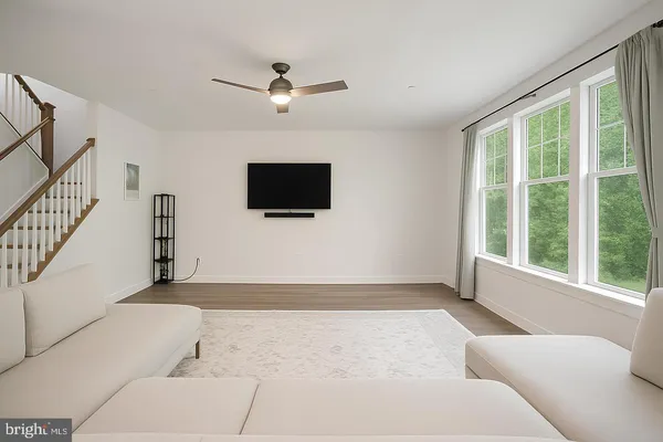 a living room with a flat screen tv and a large window