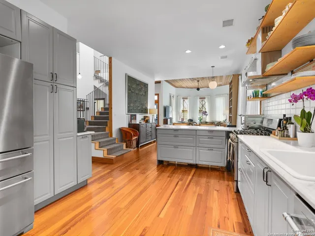 a large kitchen with a lot of counter space and stainless steel appliances
