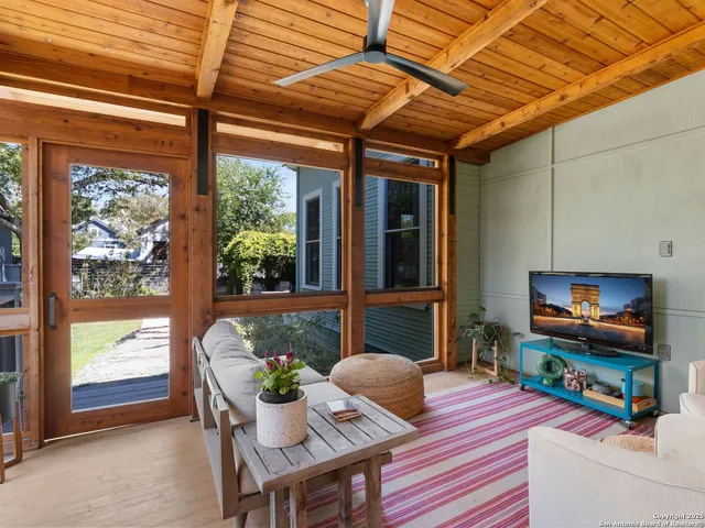 a outdoor living space with furniture and a flat screen tv