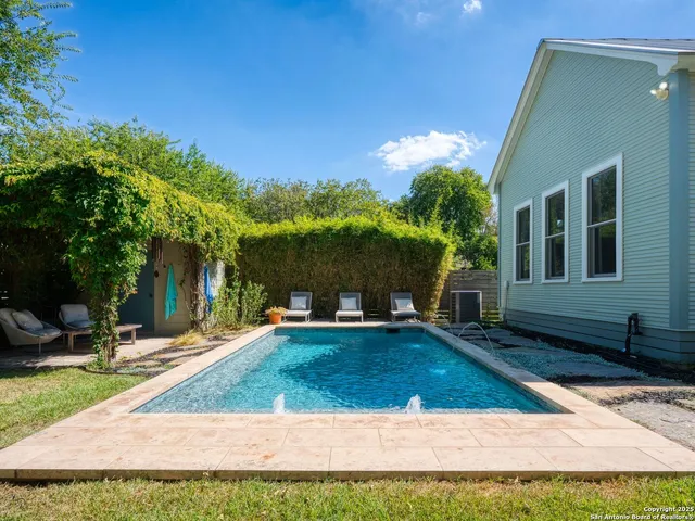 a view of a house with backyard and sitting area