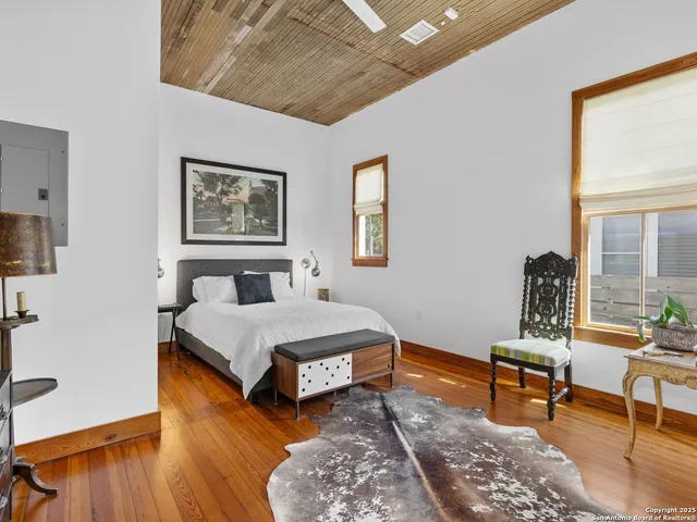 a bedroom with a bed a rug and a window