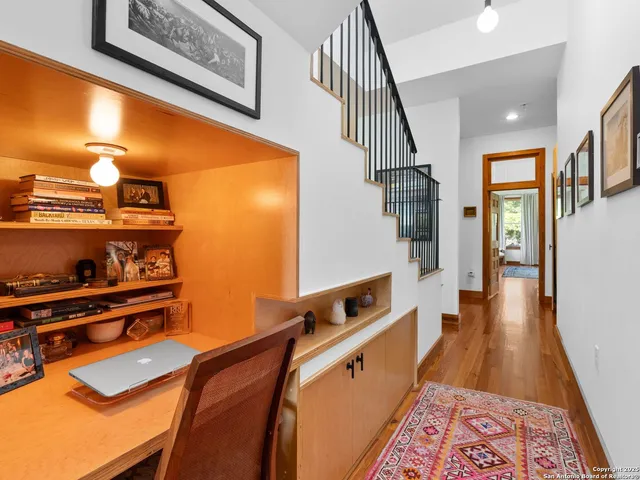 a hallway with wine table and chairs