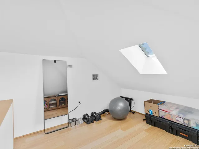 a room with a wooden floor and gym equipment