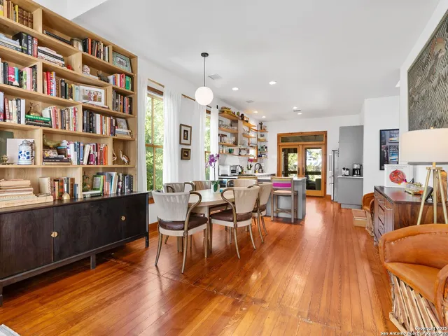 a living room with furniture and a book shelf