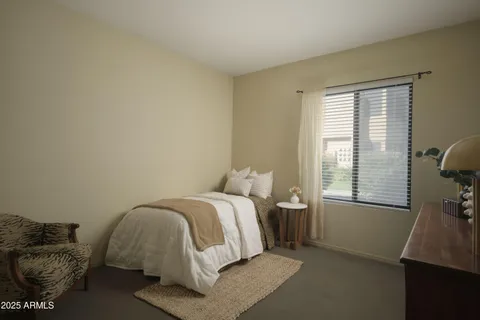 a bed room with a bed and a window