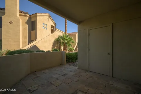 a front view of a house with a yard and potted plants