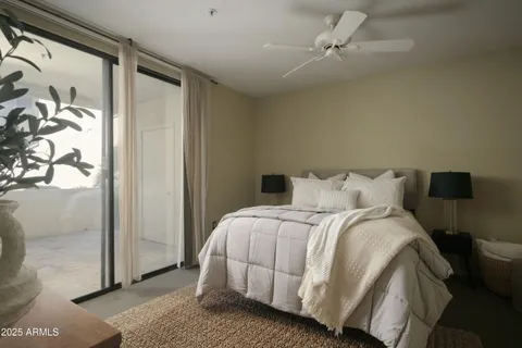 a large bed sitting in a bedroom next to a window