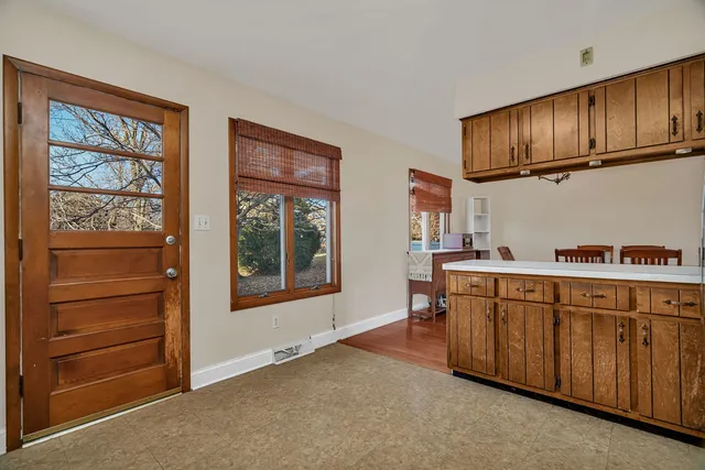 a hallway with cabinets and window