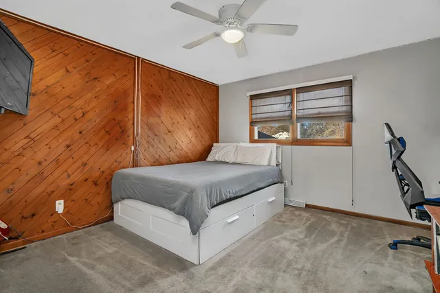 a bedroom with a bed dresser and a window