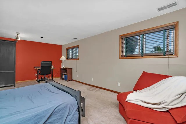 a bedroom with furniture and a window