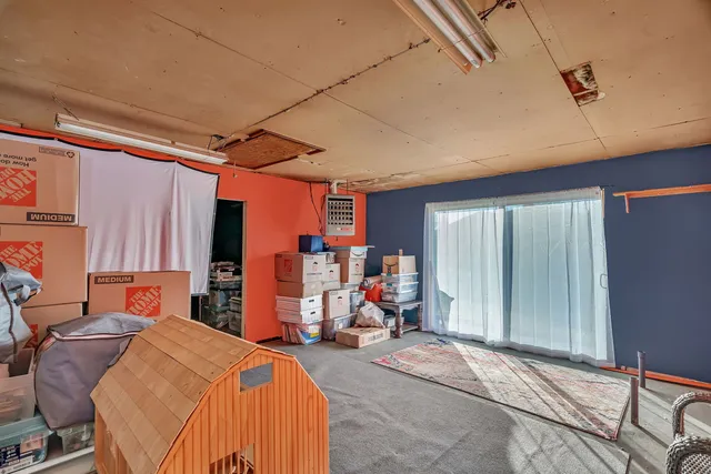 a bed room with a bed and a chair