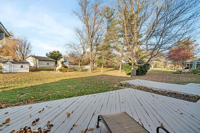 a view of a yard with wooden fence