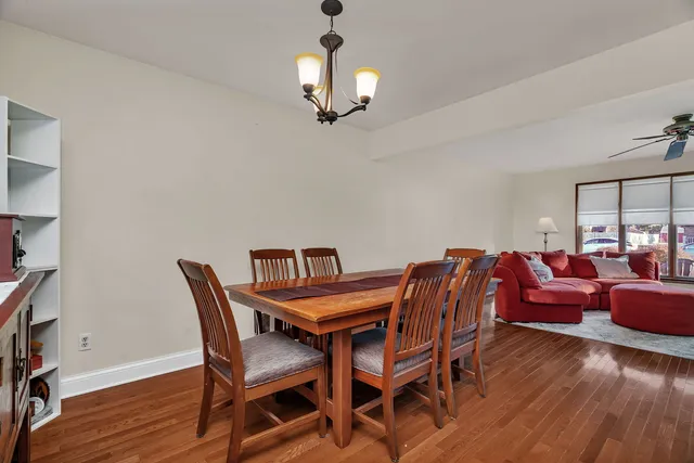 a view of a dining room with furniture wooden floor and chandelier