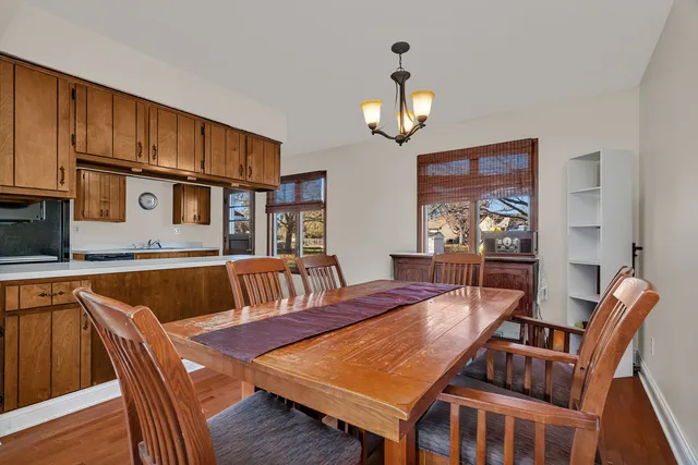 a view of a dining room with furniture wooden floor and chandelier