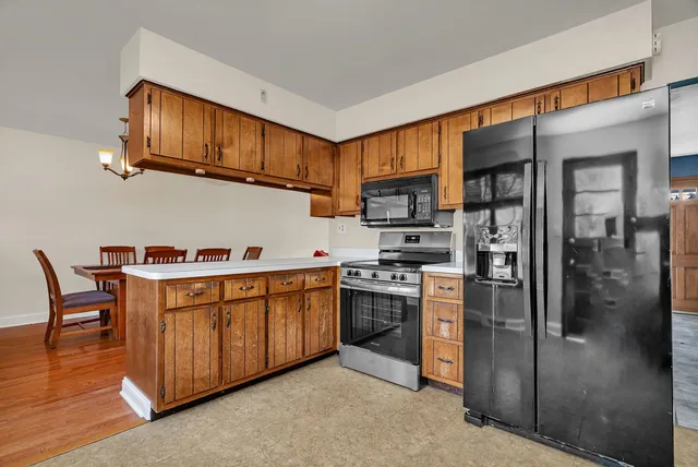 a kitchen with stainless steel appliances granite countertop a stove a sink dishwasher and a refrigerator