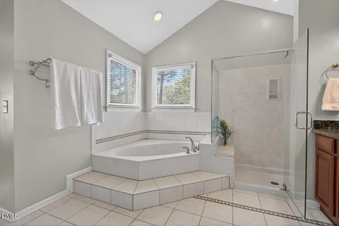 a bathroom with a granite countertop shower a sink and a mirror