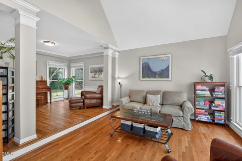 a living room with furniture and a wooden floor