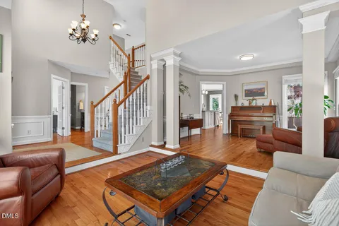 a living room with furniture and a dining table