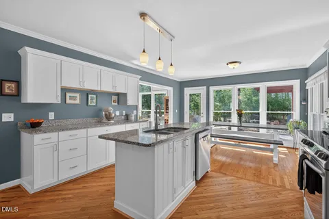 a kitchen with sink stove and cabinets