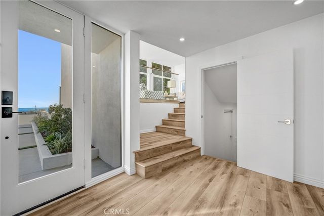 a living room with furniture kitchen view and a large window