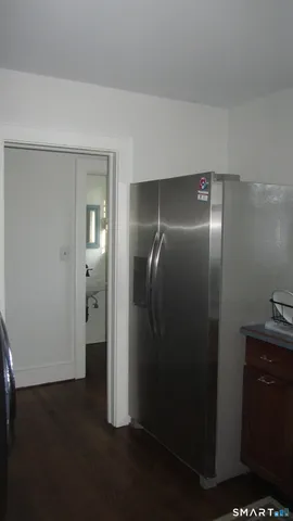 an empty room with wooden floor and a window