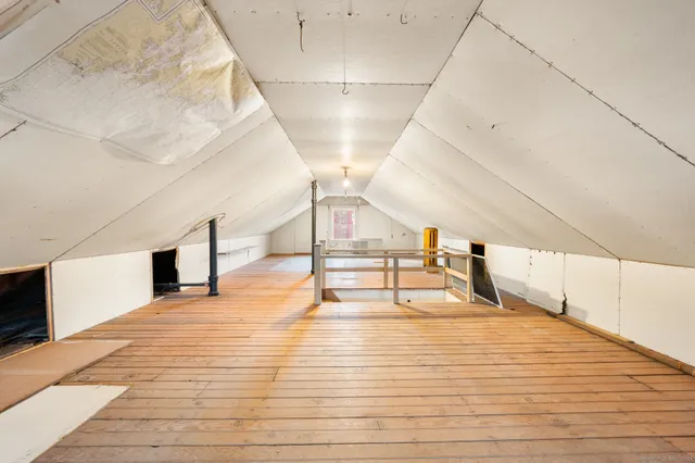 a view of an empty room with wooden roof