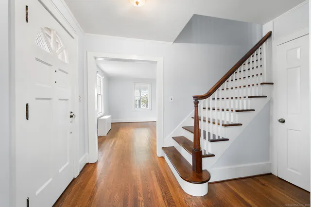 a view of empty room with wooden floor and fireplace