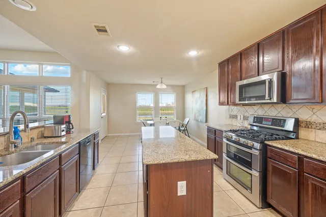 a large bed sitting in a bedroom next to a window