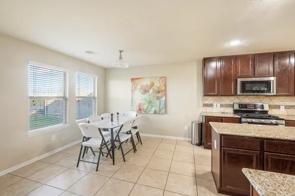 a bathroom with a sink a tub and a mirror