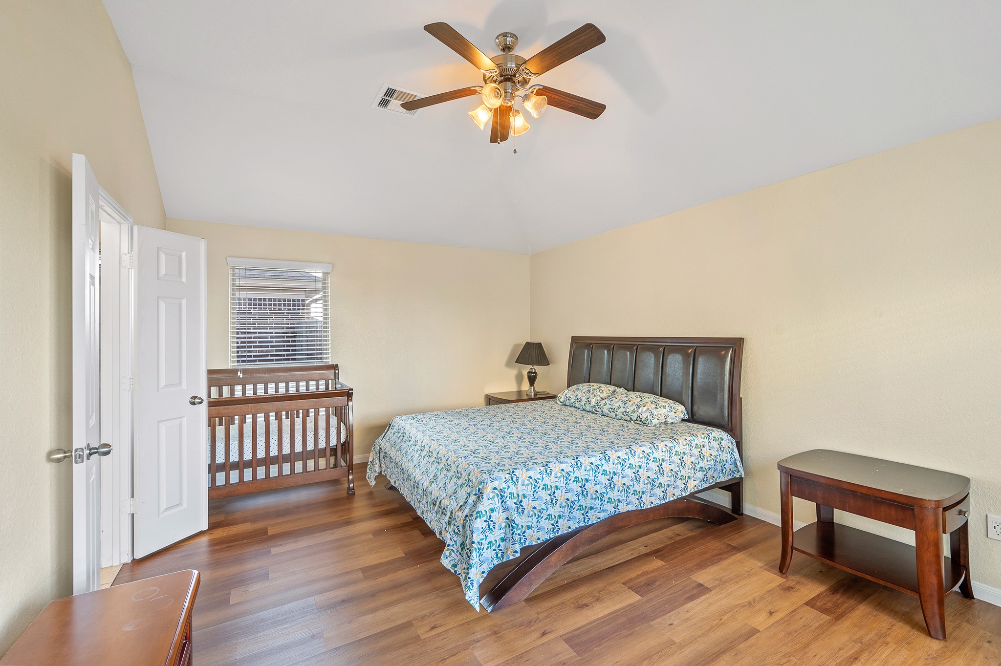 23454 Quarry Path Way Katy, TX 77493 - Photo 28 of 39 a bedroom with a bed a window and a chandelier