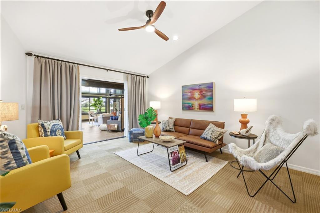 2274 Queens Way Naples, FL 34112 - Photo 8 of 28 a living room with furniture and a large window