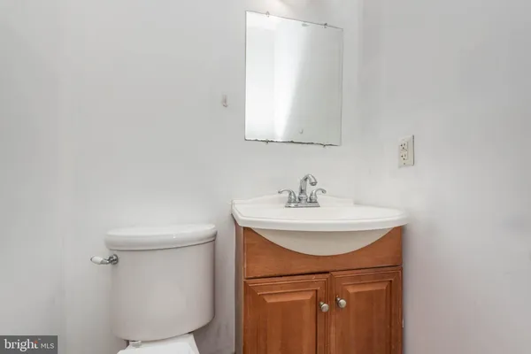 a bathroom with a sink a toilet and mirror