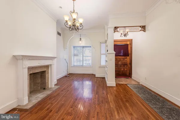 wooden floor fireplace and natural light in room
