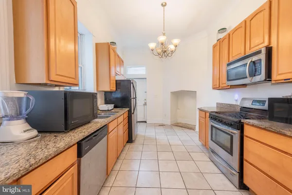 a kitchen with stainless steel appliances granite countertop a stove a sink and a granite counter tops