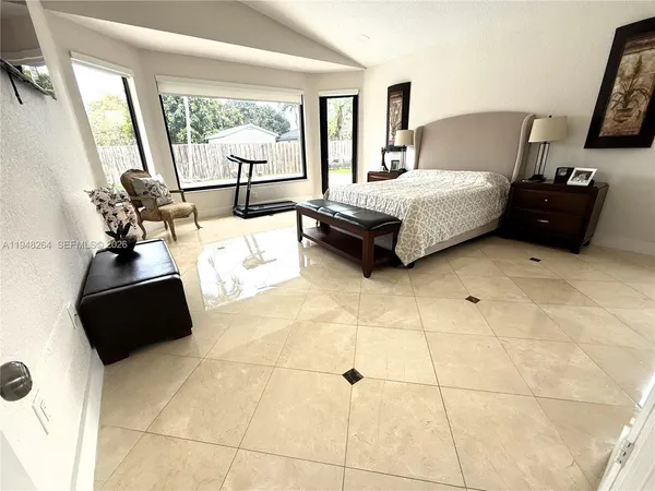 a bedroom with a bed couch and window