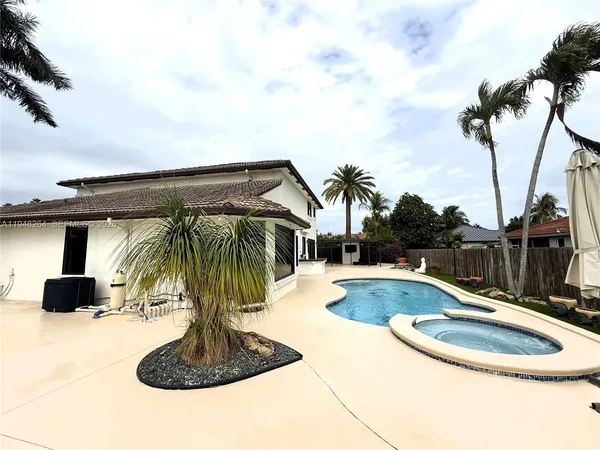 a view of a swimming pool with a yard